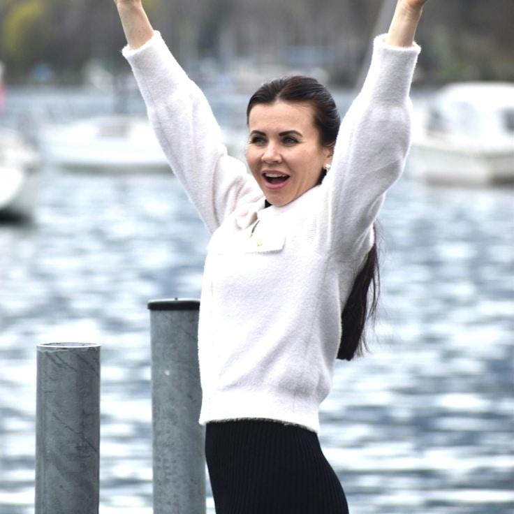 Avery Chen, Lead Design Curator at Primrose & Co., reviewing corporate floral arrangements